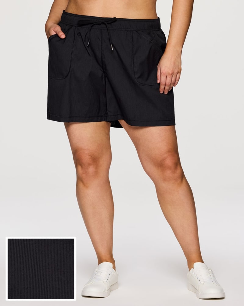 Front of a model wearing a size 1X Plus Birdie Textured Walking Short in Black by RBX Active. | dia_product_style_image_id:352942
